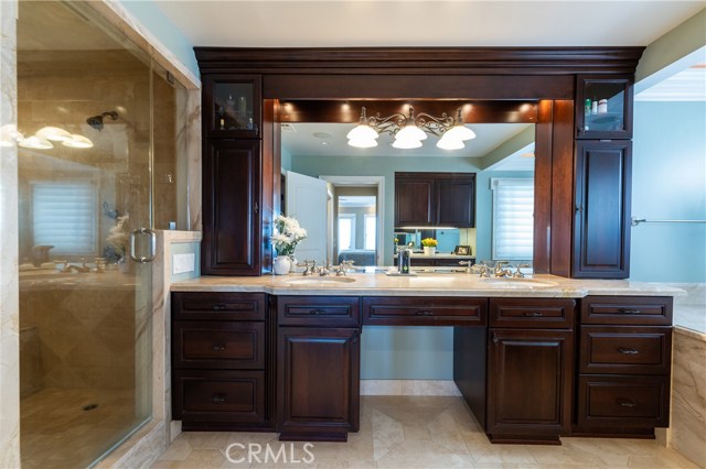 Elegant master bathroom with tons of storage, walk in shower, separate commode room, and jacuzzi tub.