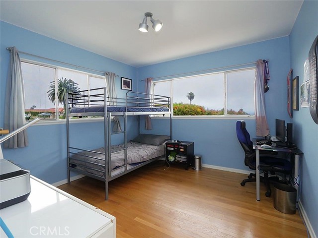 Bedroom 2 with beautiful wood floors and lots of natural light