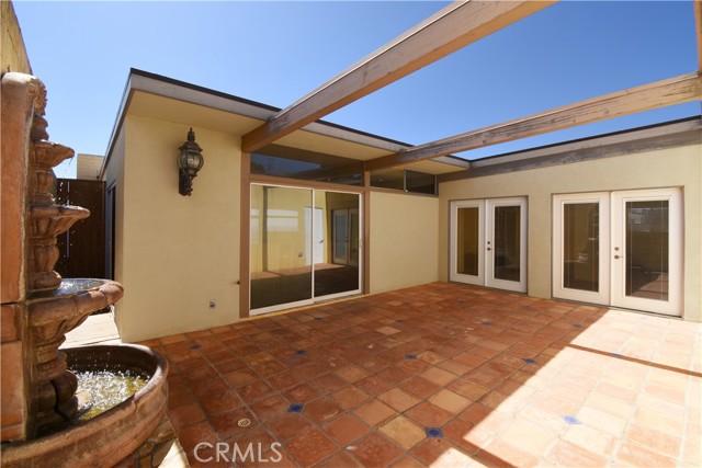 Large tiled patio with fountain easily accessed from the dining room and large entry hall.