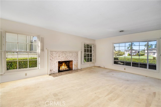 Wood burning fireplace in Living room (fire is photographer's graphic insertion, not real), picturesque view to outside