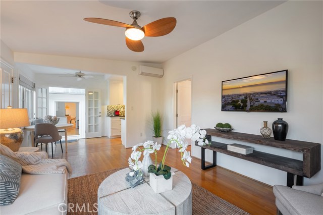 Back unit living room with air conditioning wall unit.