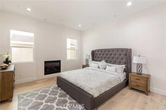 Master bedroom complete with elegantly tiled floor to ceiling fireplace