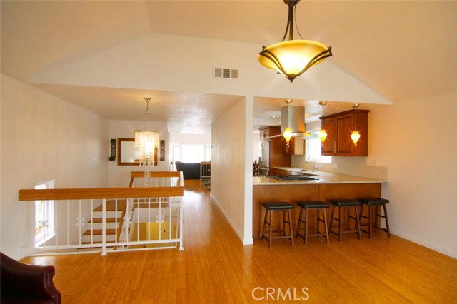 Living room view to stairs and hallway entrance to dining area.
