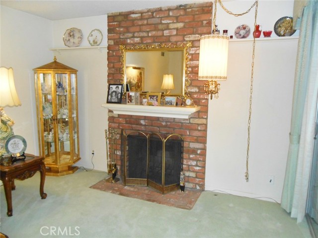 Inviting Gas Brick Fireplace with Mantel and Shelves. Great for Showing off Family Pictures and Holiday Decorating Year-round.