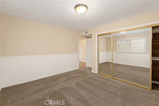 Downstairs second bedroom with mirrored wardrobe ceder lined closets.