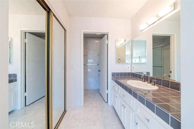 Master Vanity with one of 2 closets with separate walk in shower