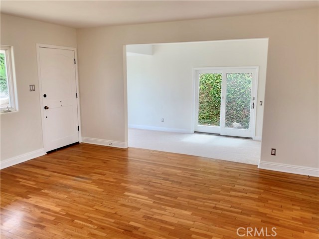 Living room, looking through step-down den to separate, side entrance sliding glass door.
