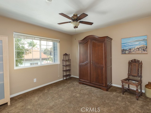 Second bedroom on upstairs level. There is a mirrored closet on wall not visible in the photo.