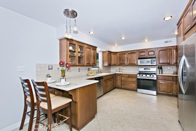 Solid-Surface counter tops, beautiful wood cabinetry, a Garden Window over the sink.