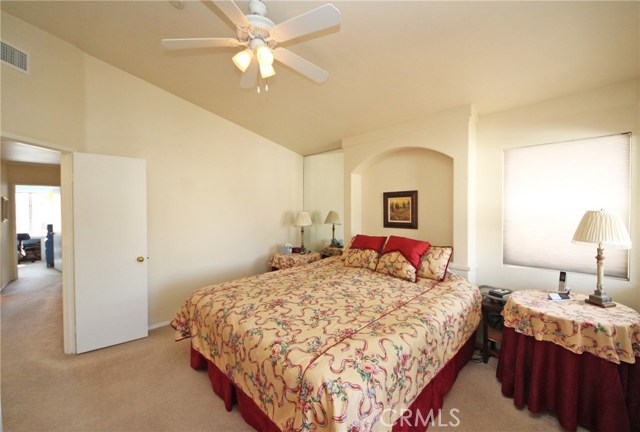 Master suite under a vaulted ceiling