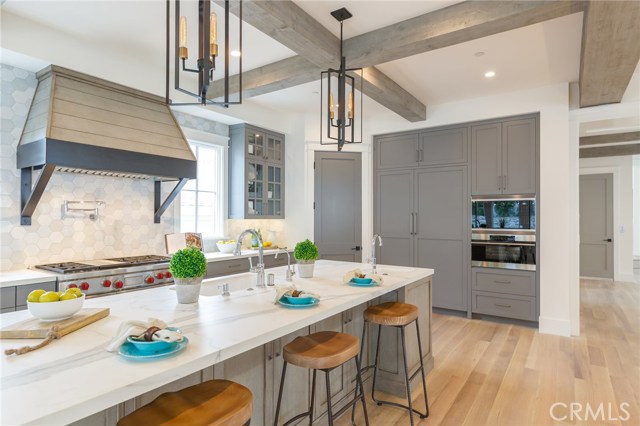 Neolith Island with two Bosch dishwashers and two sinks. Pantry wood paneled 54