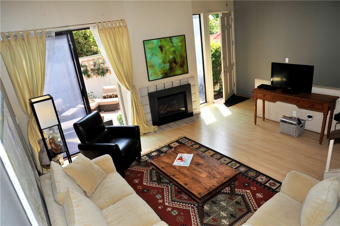 Living room with fireplace and access to patio.