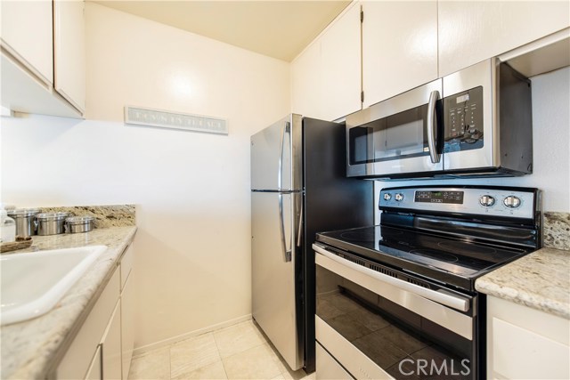 Upgraded kitchen with granite countertops, stainless appliances and tile flooring