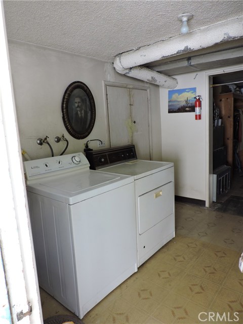 Separate laundry room with storage room next to it.  Both water heaters are located here as well.