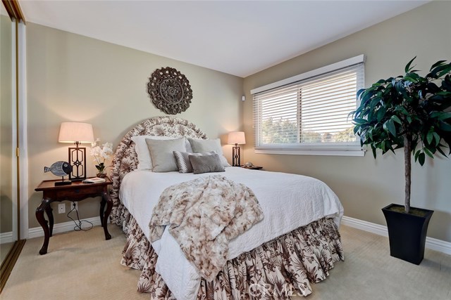 Upper level 2nd bedroom with custom window treatments can be used for kids, guests, or as an office!