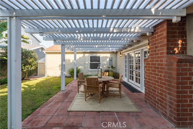 The lush and tranquil backyard with patio and pergola.