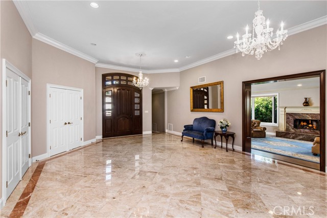 Grand marble foyer with view of the front door and family room