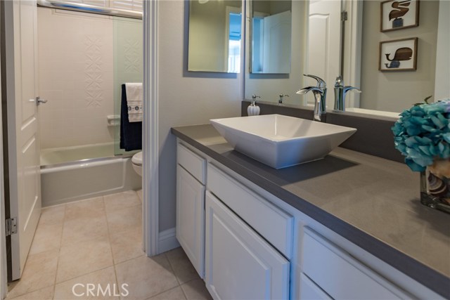 Shared bathroom with shower in tub