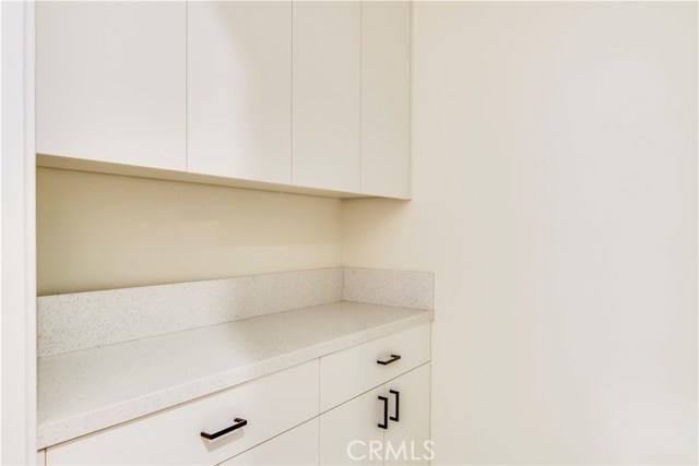 Laundry room with built in cabinets and quartz countertop