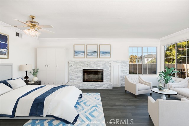 Photo has been altered to show Primary Bedroom  fireplace painted white, wood floors and oak painted white.