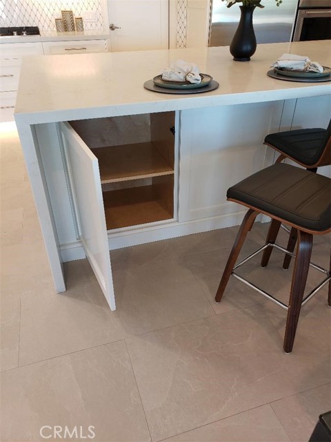 Island has lots of storage, beautiful floor tile