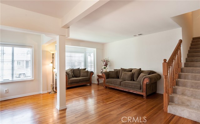 Good view of bay window and living room. Staircase leads upstairs to bedroom #4.