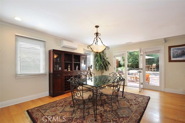 Dining area opens through french doors to the back yard