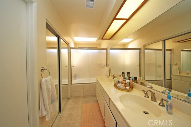 Double sinks and a large soaking tub with shower