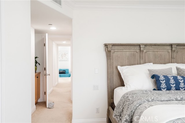 Primary bedroom features walk-in closet and extra linen cabinets behind the bedroom entry door.