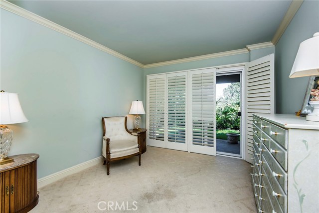 Lower guest bedroom is a cool, inviting space with designer paint, crown molding and French doors to a private patio. A full bathroom is conveniently located nearby.