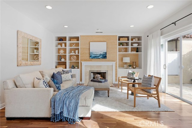 Sun-Filled Family Room with Wood Burning Fireplace (currently used with glass/gas) and Built-in Cabinetry/Shelving