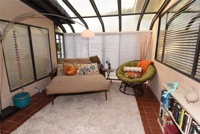 Pretty enclosed and permitted patio room is perfectly situated.  This is a super room for a reading room, guest area, or playroom!