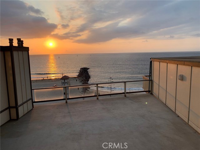 View from the Living Room of Sand, White Water, Rock Jetty and Sunset.