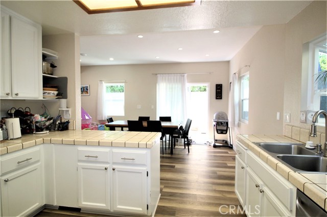Gleaming wood flooring throughout, Formal dining area leads to outside and the kitchen!