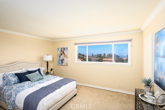 Master bedroom overlooks the blue ocean and greeneries.