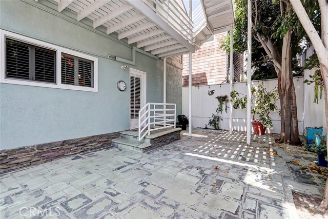 private backyard patio with trees providing shade