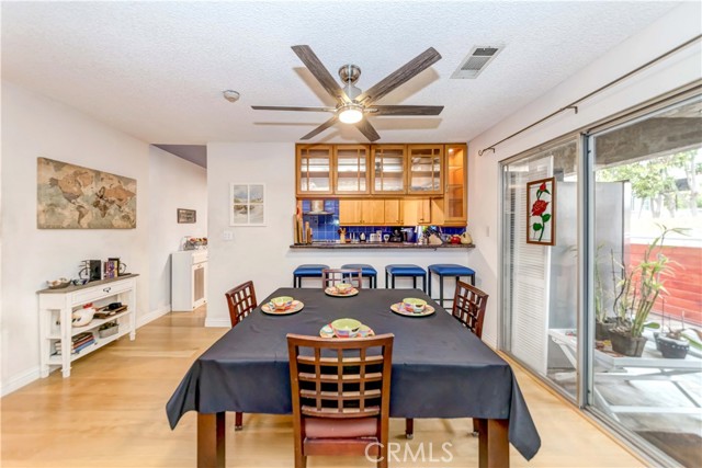 Dining area between kitchen and living room with balcony patio.