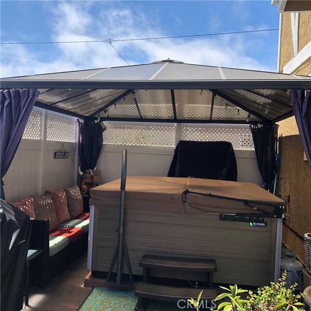 Backyard patio includes this 1 year new spa with a cover... great for a soak after a hard day at work!