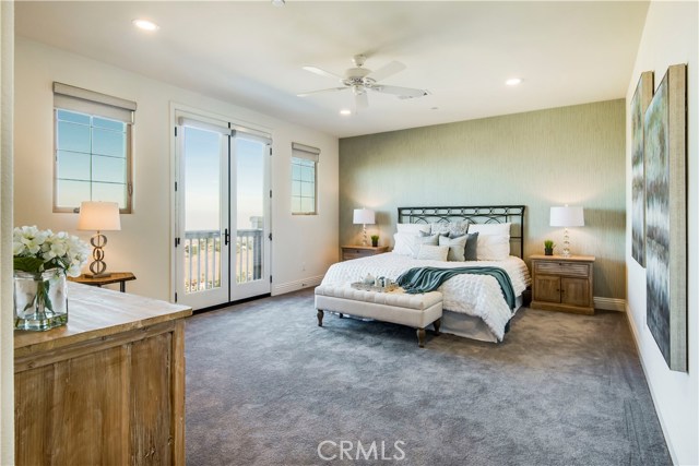 Spacious master bedroom with ceiling fan, French doors, attached bath and large walk-in closet