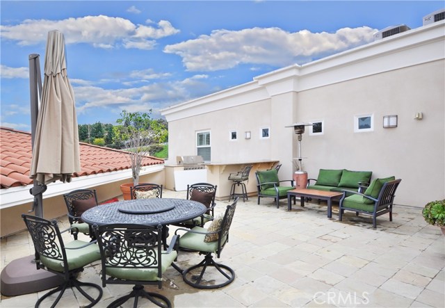 Community deck area with bar-b-que near the unit