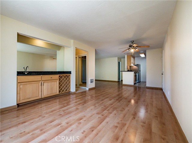 Open floorpan. Laminate wood floors, floor to ceiling windows, gas fireplace, smooth ceilings, ceiling fan, granite counter at the remodeled wet bar with wine rack. Remodeled kitchen with maple cabinets, granite counters and all brand new Samsung stainless steel appliances.