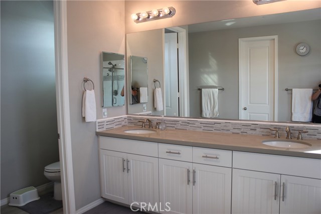 Cabinet handles in master bath with separate toilet area.