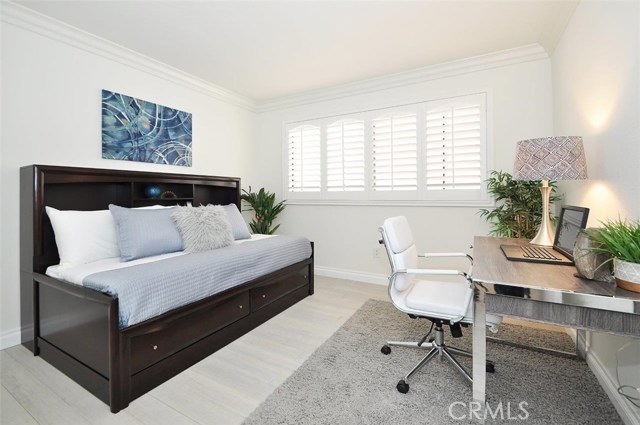 Second bedroom with Plantation shutters, bamboo wood floors, crown molding, fresh paint.