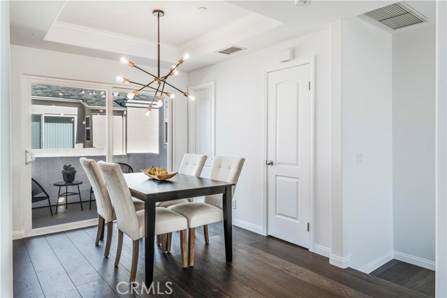 Dining area with alcove ceiling and new, contemporary sputnik lighting fixture with dimmer switch.