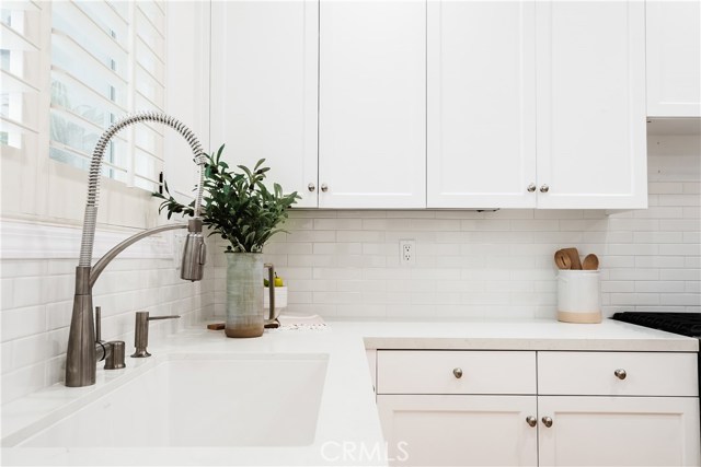 Kitchen features new quartz countertops and tile backsplash, freshly painted cabinets, matching BLANCO sink, and walk-in pantry.