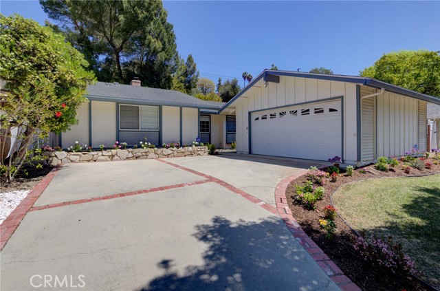 Long driveway leads to the detached 2 car garage