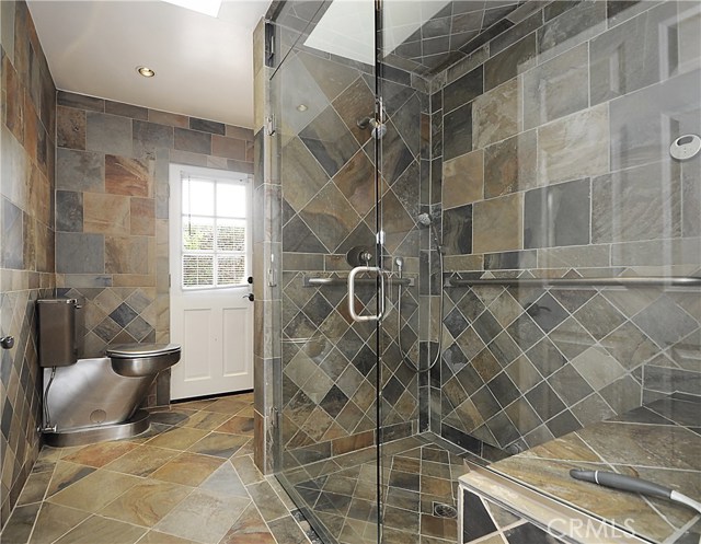 Slate/Stainless Steel Bathroom and Steam Shower with convenient access to the pool.