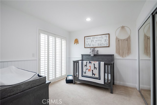 Baby's room with dimmable recessed lights and access to sunny shared deck.