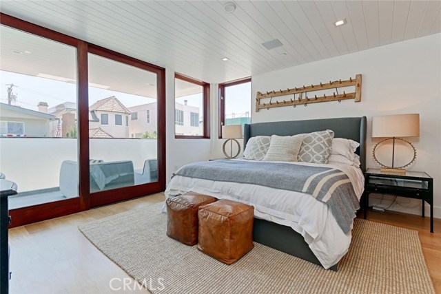 Master bedroom with deck accessible via full-length mahogany sliders