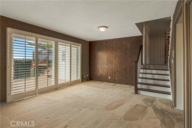 Downstairs Family Room with plantation shutters and access to lower level deck and yard